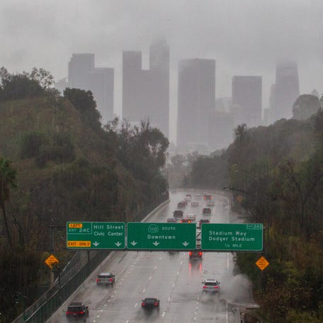 Cars ride the 110 Freeway toward downtown Los Angeles during heavy rain on Nov. 15, 2025. A multiple-day powerful atmospheric river storm triggered evacuation due to possible mudslides to areas burned by wildfires and flash flood warnings in Southern California.