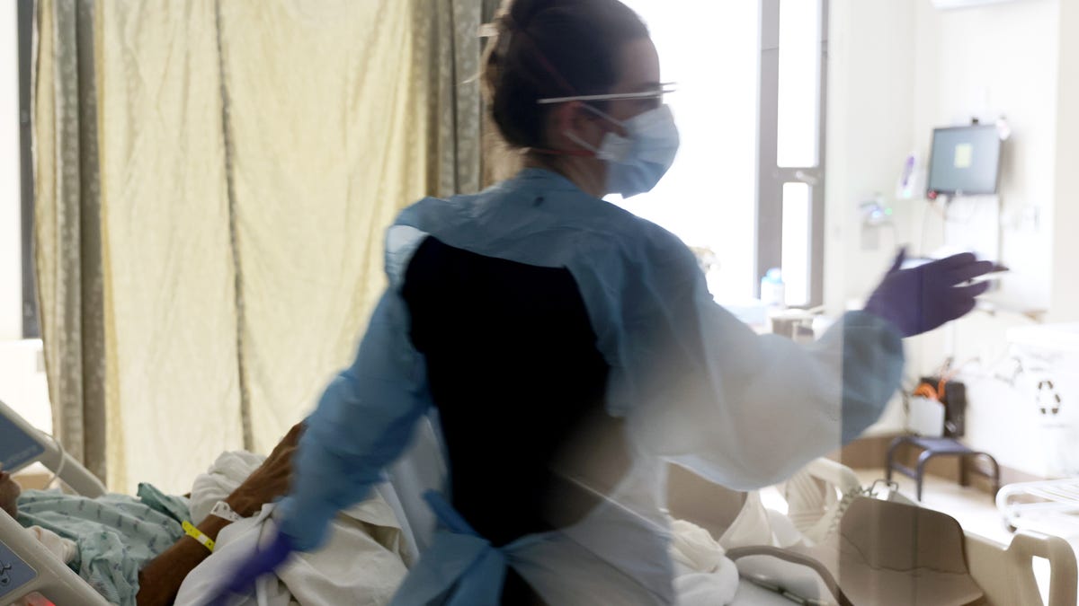 Nurse Elisa Gilbert checks on a patient in the acute care COVID-19 unit at the Harborview Medical Center on Jan. 21, 2022 in Seattle, Washington.