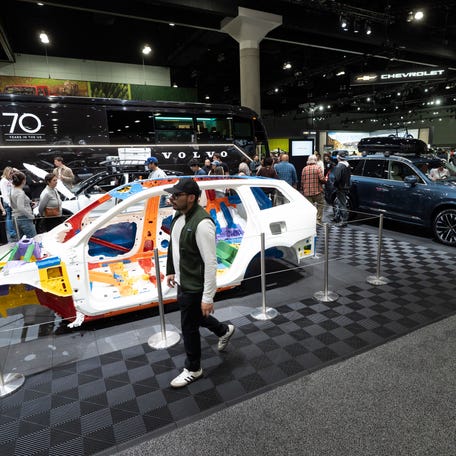 Visitors look at the Volvo exhibit at the Los Angeles Auto Show, Sunday, Nov. 23, 2025, in Los Angeles.