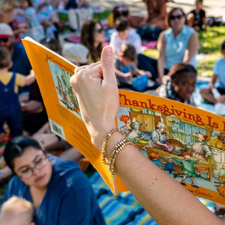 Children and families listen to a story during a preschool Thanksgiving event on Nov. 24, 2025, in Palm Beach, Florida.