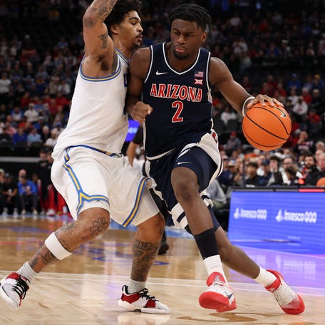 Arizona guard Dwayne Aristode (2) dribbles the ball against UCLA guard Skyy Clark (55) during the first half of their Hall of Fame Series game at Intuit Dome.