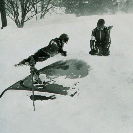 Red Cross workers search for victims buried in cars following snowfall during the Blizzard of '77 in Buffalo, New York.