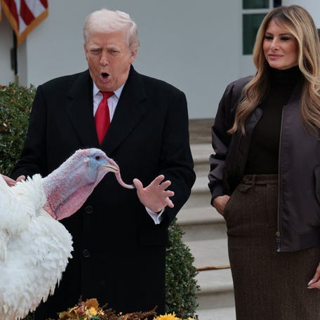 U.S. President Donald Trump and U.S. first lady Melania Trump react next to Gobble, one of two turkeys ceremonially pardoned for Thanksgiving, in the Rose Garden at the White House in Washington, D.C., U.S., November 25, 2025. REUTERS/Jonathan Ernst