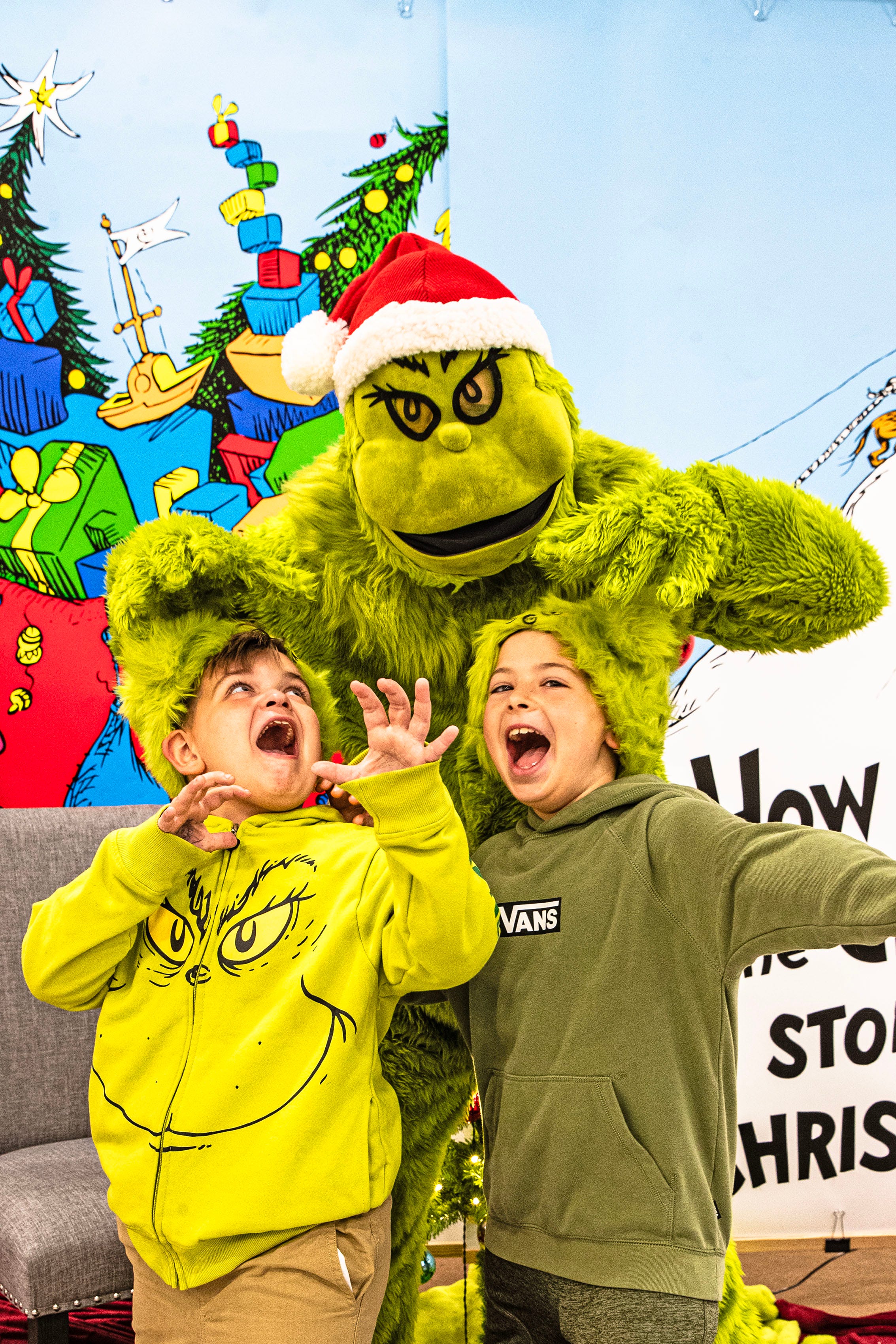 The Godwin brothers, Ayden, 7, and EJ, 9, pose for a photo with the Grinch inside Boscov’s department store during a Grinch event held in Christiana on Nov. 22, 2025.