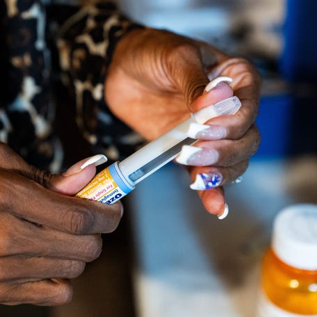 Keenya Taylor prepares her Ozempic pen after taking other medications for type-2 diabetes in the morning before work in her east Philadelphia home on Wednesday, Sept. 6, 2023.