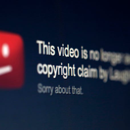 A picture illustration shows a screen with a YouTube copyright message regarding a video.