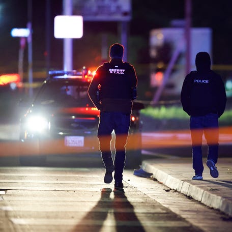 Members of the police walk at the scene after several people were shot at a family gathering in Stockton, California, U.S. November 29, 2025.