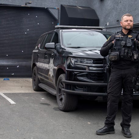 A San Joaquin County Sheriff's deputy stands guard in front of a banquet hall at The Outpost shopping center onLucille Avenue near Thornton Road in Stockton on Nov. 30, 2025 where a mass shooting at a children's birthday party occurred on Saturday, Nov. 29. Four people died and 11 were injured in the shooting.