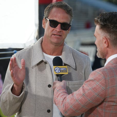 Mississippi football coach Lane Kiffin speaks with ESPN reporter Marty Smith before his team's game against Mississippi State at Davis Wade Stadium at Scott Field.