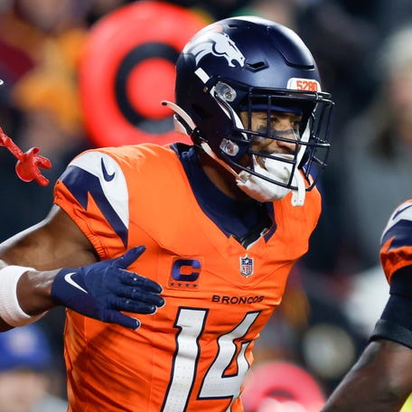 Nov 30, 2025; Landover, Maryland, USA; Denver Broncos wide receiver Courtland Sutton (14) celebrates after scoring a touchdown against the Washington Commanders with wide receiver Troy Franklin (11) and running back Tyler Badie (28) in the second quarter of the game at Northwest Stadium. Mandatory Credit: Peter Casey-Imagn Images