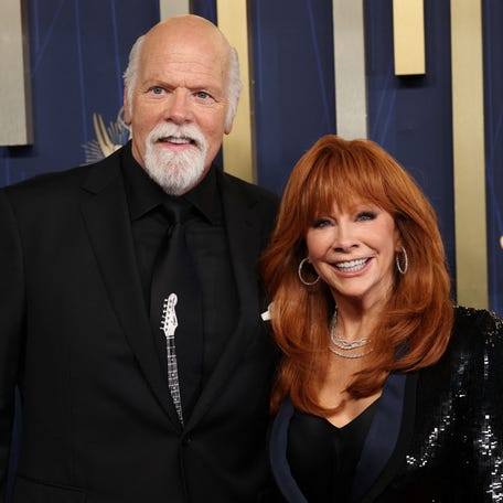 Reba McEntire, right, and Rex Linn arrive for the 77th Primetime Emmy Awards at the Peacock Theatre at LA Live in Los Angeles on Sept. 14, 2025.
