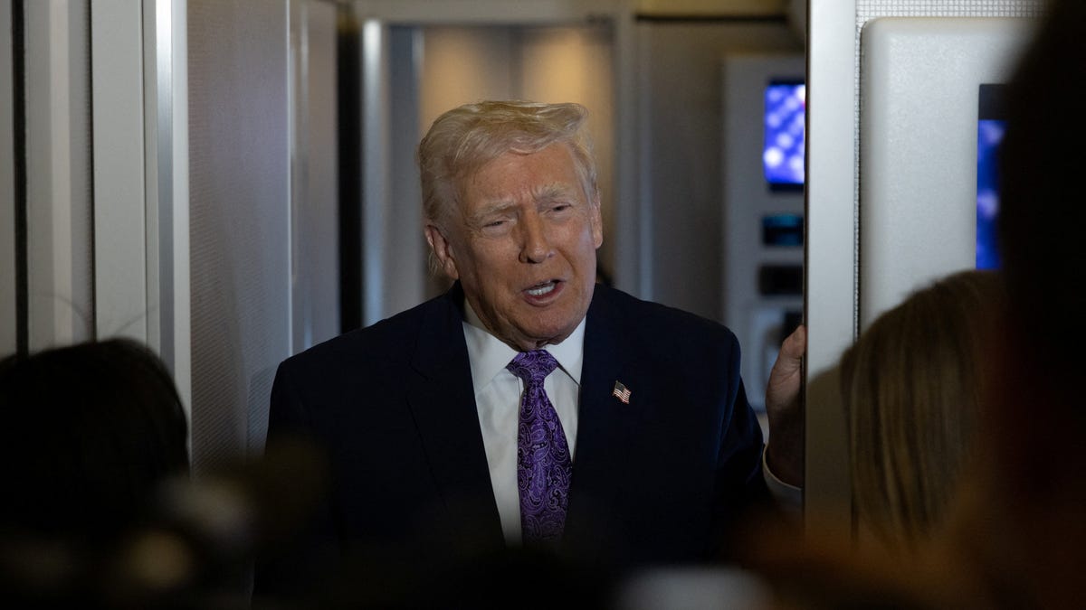 President Donald Trump speaks to reporters during travel to Washington, D.C., from Palm Beach International Airport, Florida, U.S., November 30, 2025.