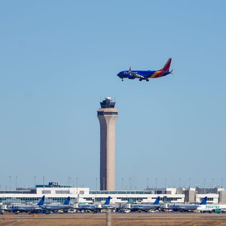 Southwest Airlines Flight 1589, operated by a Boeing 737 MAX 8 aircraft, comes in for a landing in front of the air traffic control tower at Denver International Airport on Nov. 9, 2025.