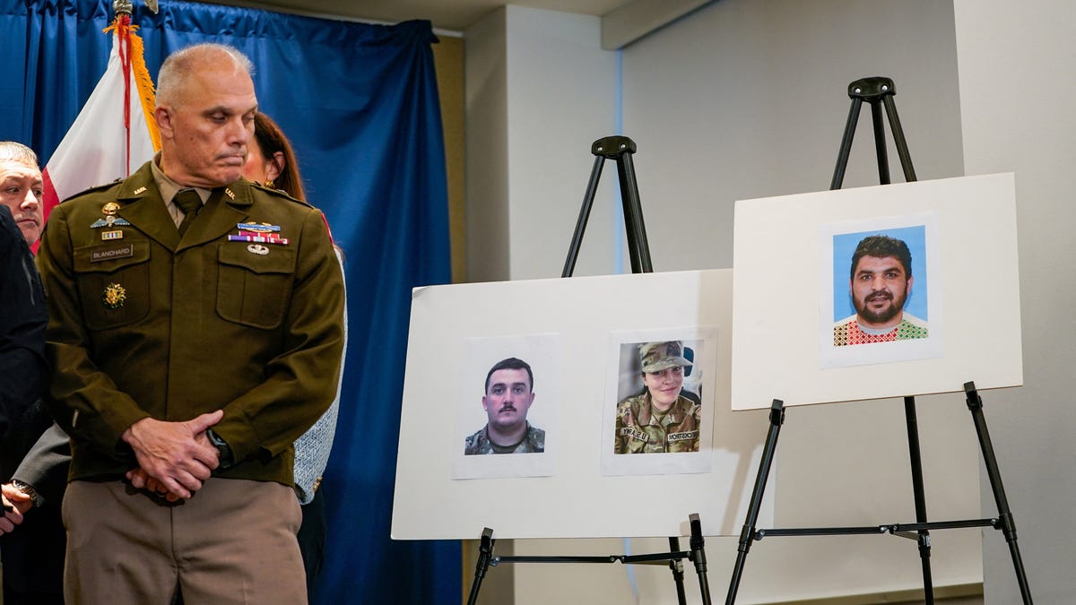 Brigadier General Leland D. Blanchard II looks towards pictures of two National Guard members who were shot in Washington on November 26, along with a picture of a suspect, Afghan national Rahmanullah Lakanwal, at a press conference with FBI Director Kash Patel, attorney Jeanine Pirro and other authorities in Washington, D.C., U.S., November 27, 2025. REUTERS/Nathan Howard