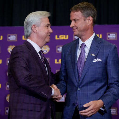 Dec 1, 2025; Baton Rouge, LA, USA; LSU president Wade Rousse, left, and LSU new head coach Lane Kiffin greet each other at South Stadium Club at Tiger Stadium. Mandatory Credit: Matthew Hinton-Imagn Images