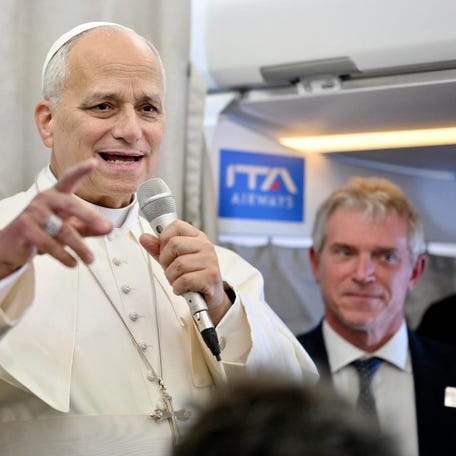 Pope Leo XIV speaks to journalists aboard a flight to Rome at the end of his apostolic journey to Turkey and Lebanon, on December 2, 2025.