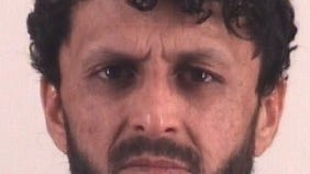 Mohammad Alokozay, a 30-year-old Afghan citizen charged with making terroristic threats, in a booking photo taken after his arrest in Fort Worth, Texas, on Nov. 25, 2025.