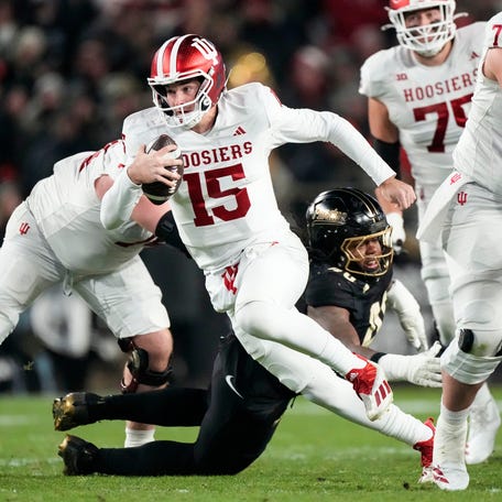 Indiana Hoosiers quarterback Fernando Mendoza (15) rushes up the field Friday, Nov. 28, 2025, during the 100th annual Old Oaken Bucket game at Ross-Ade Stadium in West Lafayette.