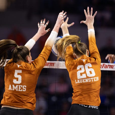 Texas middle blocker Ayden Ames and outside hitter Whitney Lauenstein wearing TIYs in their hair during a match.