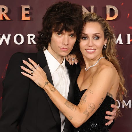 Maxx Morando and Miley Cyrus attend the Global Premiere of 20th Century Studios' "Avatar: Fire And Ash" at Dolby Theatre on Dec. 1, 2025, in Hollywood, California.