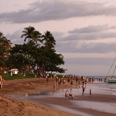 LAHAINA, HAWAII - AUGUST 05: People gather on Kaanapali Beach, a popular tourist destination, on August 5, 2024 near Lahaina, Hawaii.