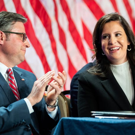 Rep. Elise Stefanik (right), R-New York, is acknowledged by President-elect Donald Trump alongside Speaker of the House Mike Johnson (left), R-Louisiana, during a House Republicans Conference meeting on Nov. 13, 2024, in Washington, DC.