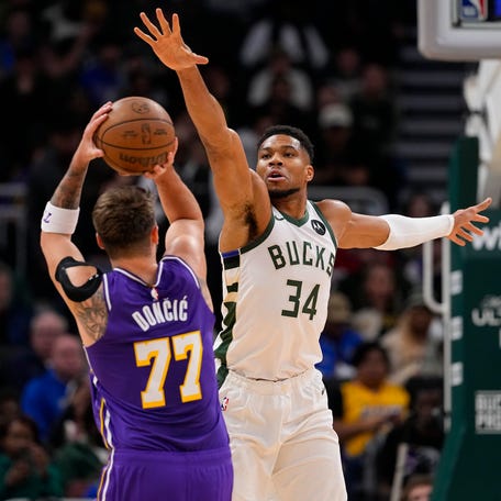 Milwaukee Bucks forward Giannis Antetokounmpo (34) defends Los Angeles Lakers guard Luka Doncic (77) Nov 15, 2025 at Fiserv Forum: Jeff Hanisch-Imagn Images