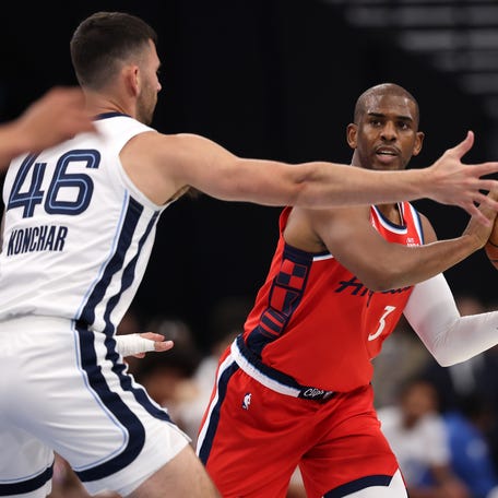 Los Angeles Clippers guard Chris Paul (3) looks to pass the ball against Memphis Grizzlies guard John Konchar (46) during the first half at Intuit Dome in Inglewood, California, on Nov. 28, 2025.