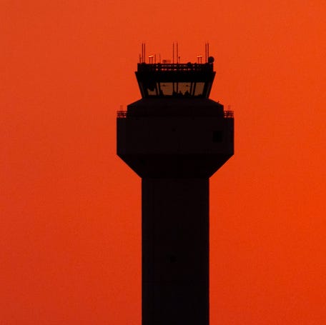 A private jet passes the control tower as it lands at Palm Beach International Airport on November 9, 2025, in West Palm Beach, Florida.