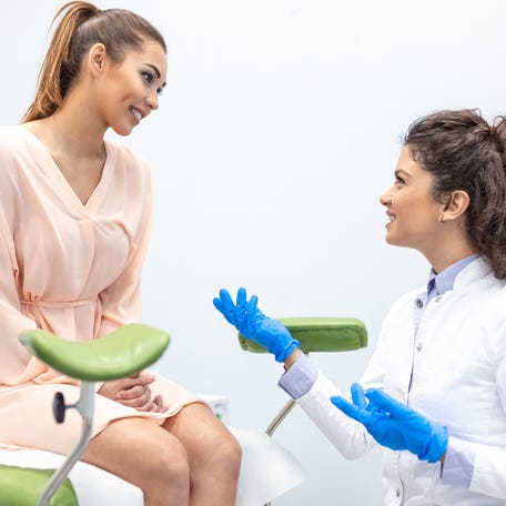 Gynecologist talking with a young female patient during a medical consultation in the gynecological office