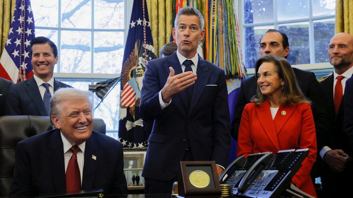 U.S. Transportation Secretary Sean Duffy speaks as U.S. President Donald Trump and U.S. Rep Lisa McClain (R-MI) react, and Stellantis CEO Antonio Filosa looks on, during the announcement of new fuel economy standards, in the Oval Office at the White House in Washington, D.C., U.S., December 3, 2025.