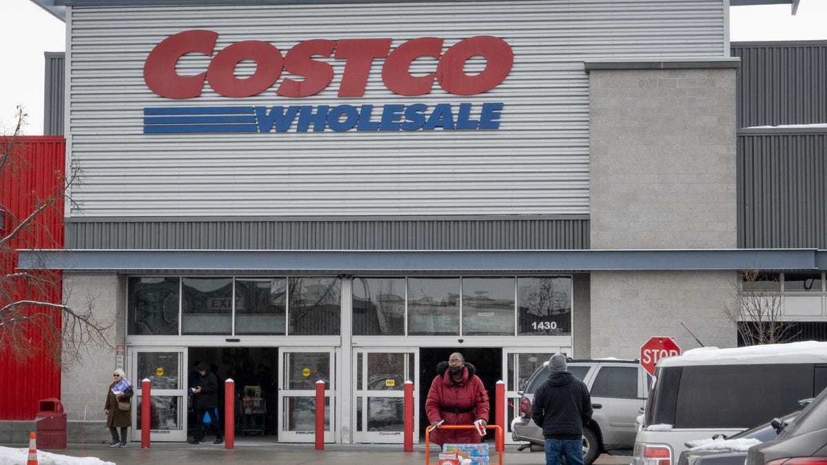 Customers walk in the parking lot outside a Costco store on December 02, 2025 in Chicago, Illinois. Costco is suing the Trump administration for a refund of tariffs the company alleges were improperly imposed by President Trump. The company contends that only Congress has the power to impose tariffs. (Photo by Scott Olson/Getty Images)