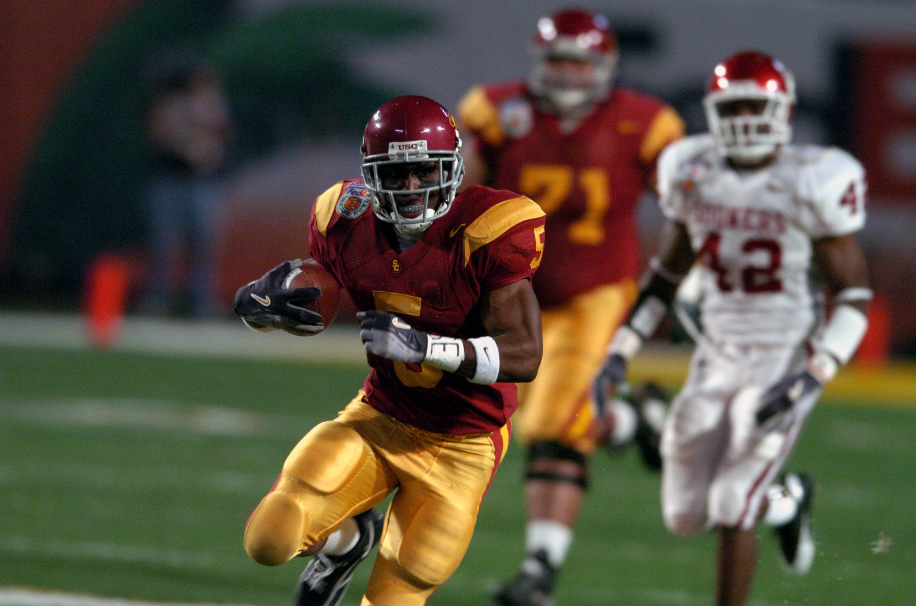 Jan 4, 2005; Miami Gardens, FL, USA; Southern California Trojans tailback Reggie Bush heads up field on the first play form scrimmage in a 55-19 victory over Oklahoma in the FedEx Orange Bowl during the BCS National Championship at Pro Player Stadium.