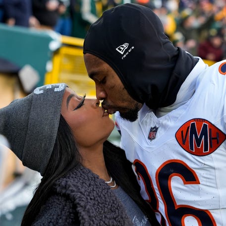GREEN BAY, WISCONSIN - DECEMBER 07: Simone Biles and Jonathan Owens #36 of the Chicago Bears kiss before the game against the Green Bay Packers at Lambeau Field on December 07, 2025 in Green Bay, Wisconsin. (Photo by Patrick McDermott/Getty Images)