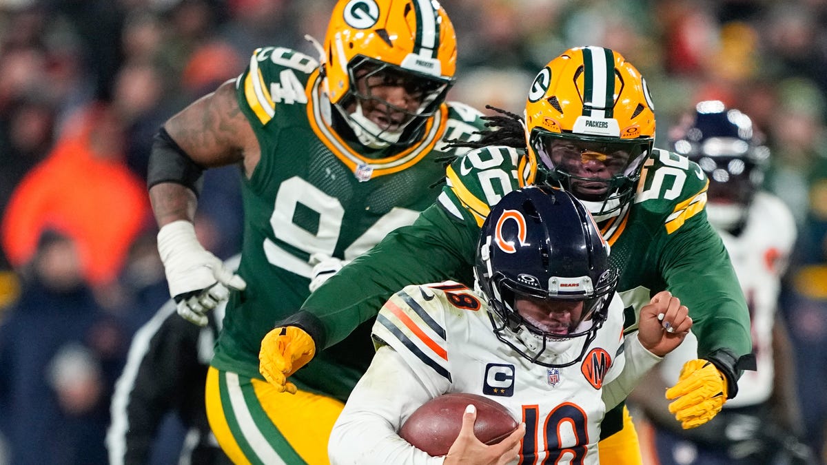 Dec 7, 2025; Green Bay, Wisconsin, USA; Chicago Bears quarterback Caleb Williams (18) is tackled by Green Bay Packers defensive lineman Rashan Gary (52) in the third quarter at Lambeau Field. Mandatory Credit: Jeff Hanisch-Imagn Images
