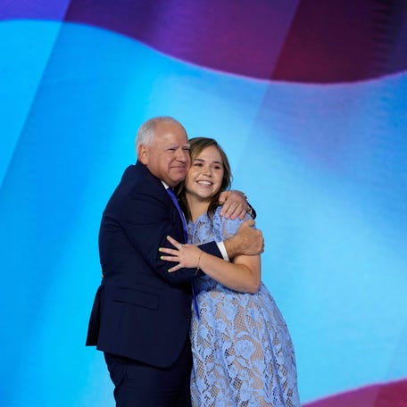 Democratic Vice Presidential nominee Tim Walz embraces his daughter, Hope Walz, after his acceptance speech during the third day of the Democratic National Convention at the United Center on Aug. 21, 2024 in Chicago, Ill.