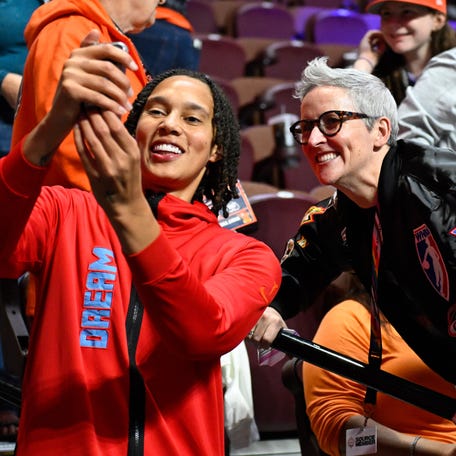 Atlanta Dream center Brittney Griner (42) takes a selfie with a fan before a game against the Connecticut Sun at Mohegan Sun Arena. Mandatory Credit: Eric Canha-Imagn Images