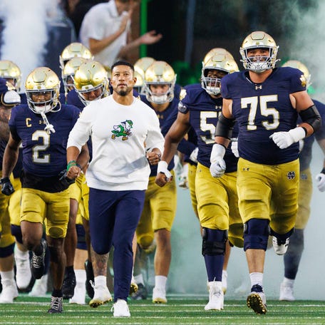 Notre Dame head coach Marcus Freeman takes the field with his team before a NCAA football game against Texas A&M at Notre Dame Stadium on Saturday, Sept. 13, 2025, in South Bend.