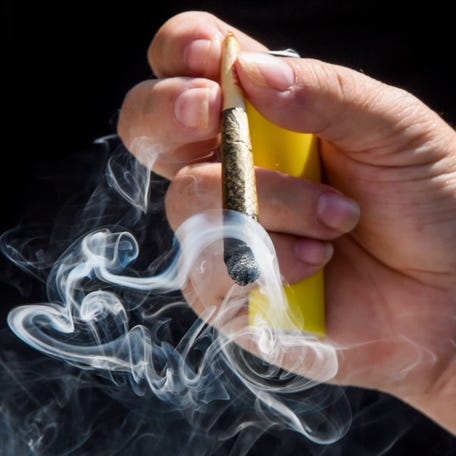 Protesters gather and smoke legal cannabis on the steps of the state capitol in Montgomery, Alabama, on June 28, 2025.