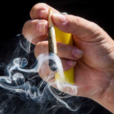 Protestors gather and smoke legal cannabis on the steps of the state capitol building in Montgomery, Alabama on June 28, 2025.