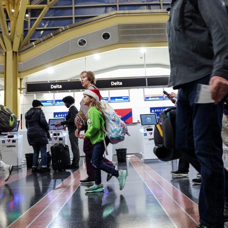 ARLINGTON, VIRGINIA - NOVEMBER 25: Travelers walk through the Ronald Reagan Washington National Airport on November 25, 2025 in Arlington, Virginia.