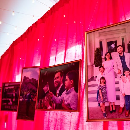 An exterior hallway of photographs stretches between a celebratory tent and the vice president's house on the grounds of the Naval Observatory on Dec. 8, 2025.