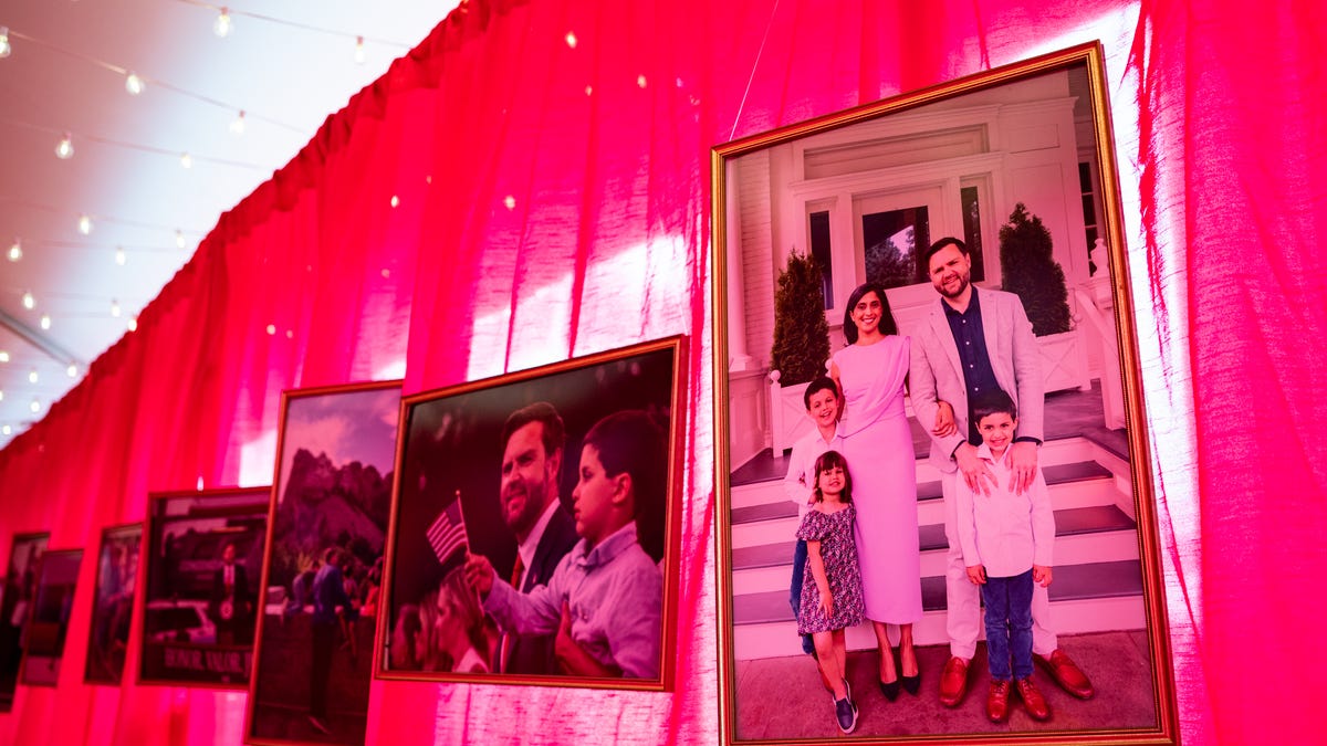 An exterior hallway of photographs stretches between a celebratory tent and the vice president's house on the grounds of the Naval Observatory on Dec. 8, 2025.