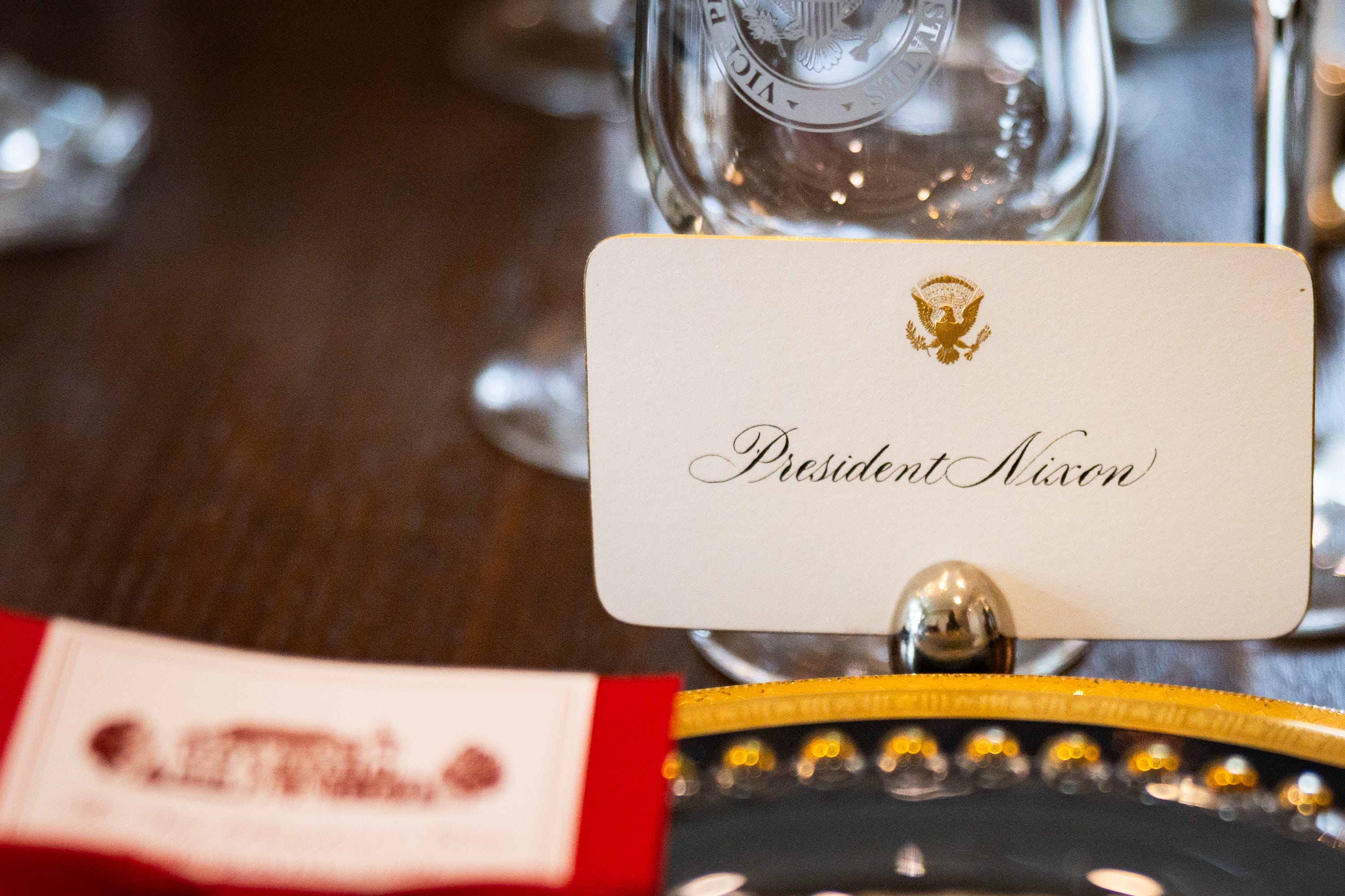 A faux seating chart featuring past presidents, vice presidents, and their families is laid out among the dinnerware as part of the holiday decorations at the vice president’s residence on the grounds of the Naval Observatory on Dec. 8, 2025.