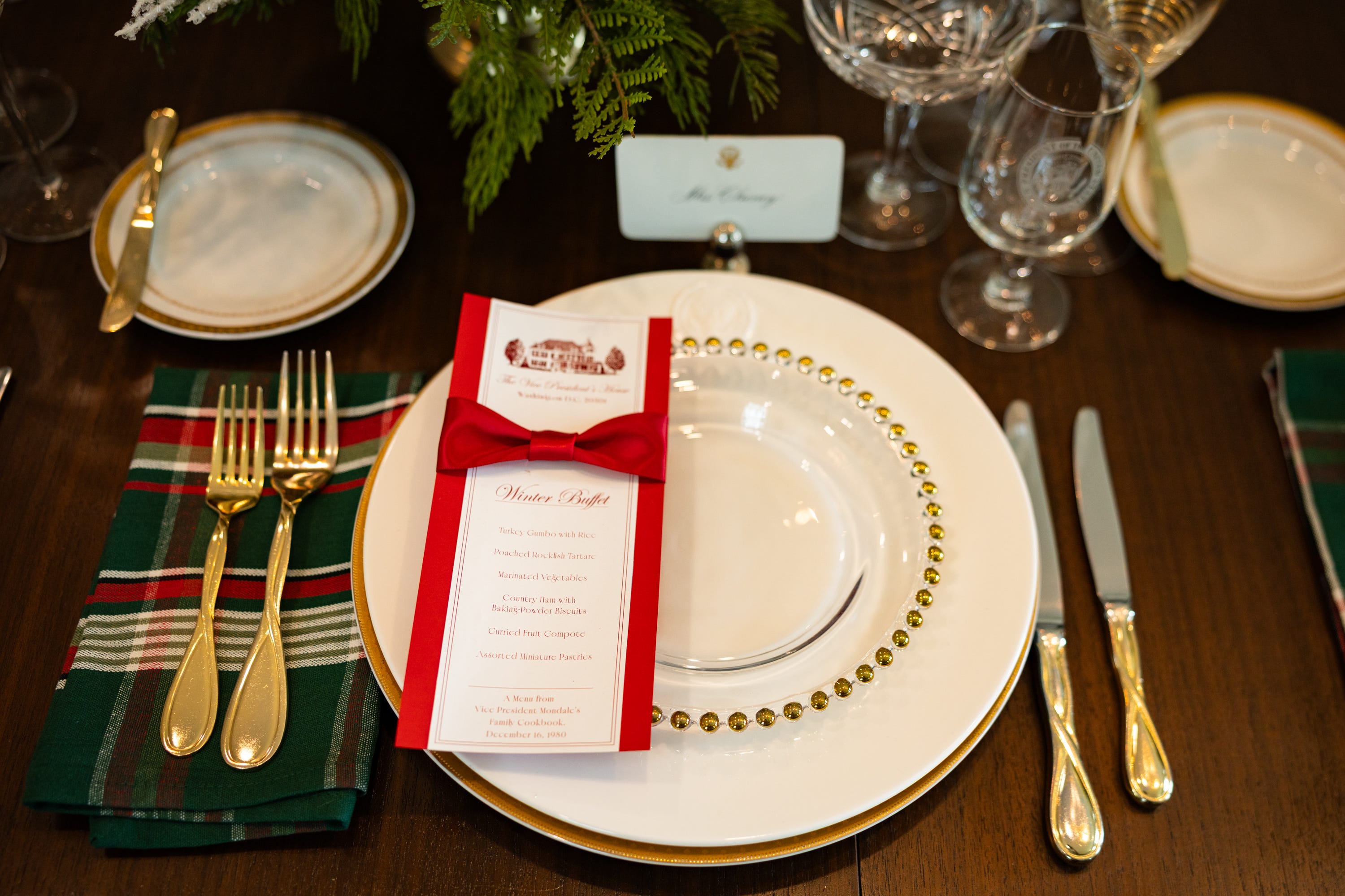 A faux seating chart featuring past presidents, vice presidents, and their families is laid out among the dinnerware as part of the holiday decorations at the vice president’s residence on the grounds of the Naval Observatory on Dec. 8, 2025.