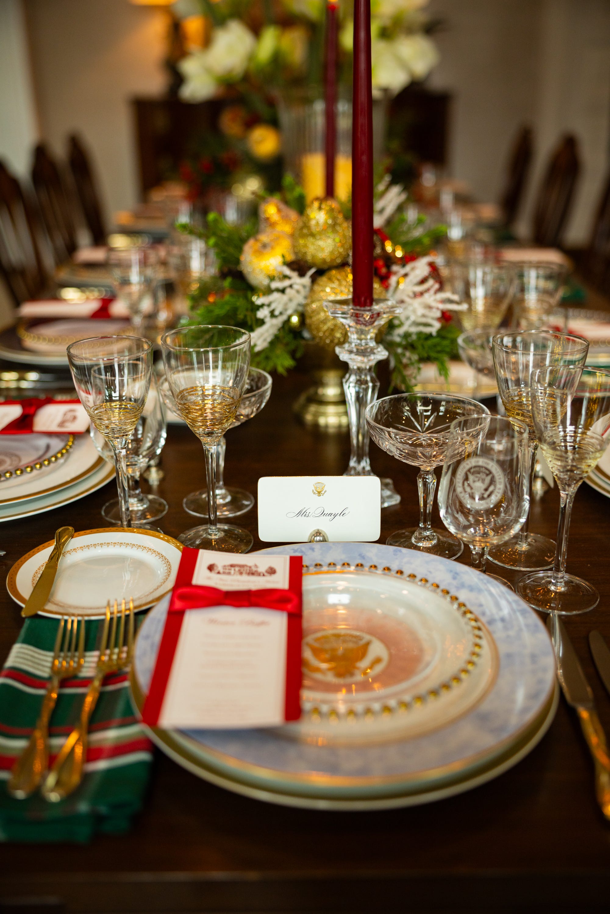 A faux seating chart featuring past presidents, vice presidents, and their families is laid out among the dinnerware as part of the holiday decorations at the vice president’s residence on the grounds of the Naval Observatory on Dec. 8, 2025.