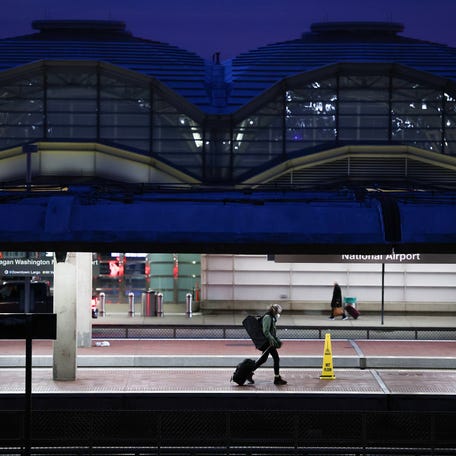 ARLINGTON, VIRGINIA - NOVEMBER 25: A person walks on a metro platform near Ronald Reagan Washington National Airport on November 25, 2025 in Arlington, Virginia.