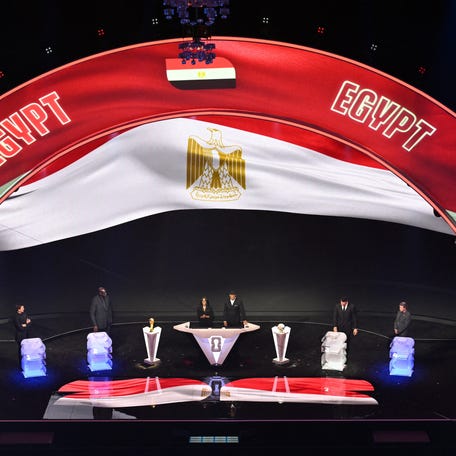 Egypt's flag is displayed on a screen during the draw for the 2026 FIFA Football World Cup taking place in the US, Canada and Mexico, at the Kennedy Center, in Washington, DC, on December 5, 2025. (Photo by Roberto SCHMIDT / AFP)