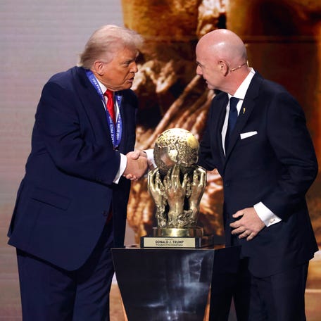 FIFA President Gianni Infantino presents United States President Donald Trump with the FIFA Peace Prize during the FIFA World Cup 2026 Final Draw at the John F. Kennedy Center for the Performing Arts.