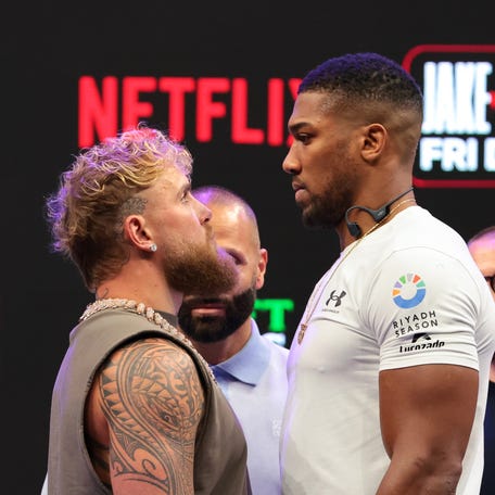 Jake Paul and Anthony Joshua face off after a press conference announcing their heavyweight boxing match at Kayesa Center Nov 21, 2025.